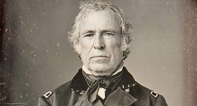 Portrait of older man with white hair wearing dark military coat and bow tie