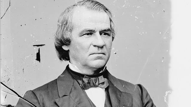 Black and white portrait photograph of a man in formal attire with bow tie