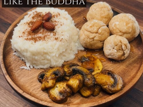 Wooden plate with creamed rice topped with almonds, roasted potatoes, and round pastries