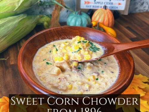 Creamy soup with corn kernels and herbs in wooden bowl with spoon