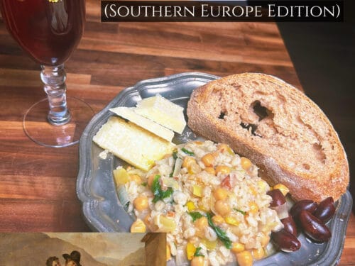 Metal plate holding sliced cheese, toasted bread, grain and vegetable mixture with red wine glass