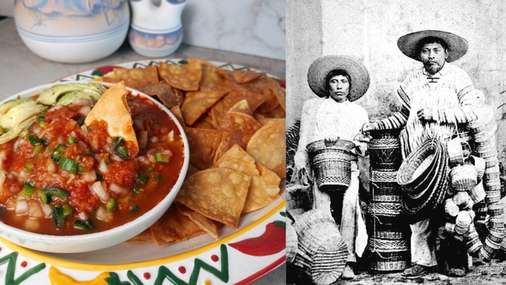 Red tomato sauce with chopped herbs and onions in white bowl, served with fried tortilla chips