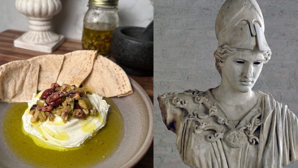 Whipped cheese topped with chopped olives and red pieces, drizzled with olive oil, served with flatbread