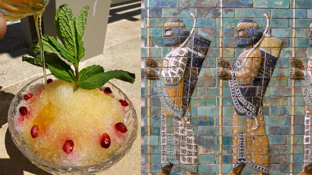 Golden syrup drink in glass bowl garnished with mint leaves and pomegranate seeds