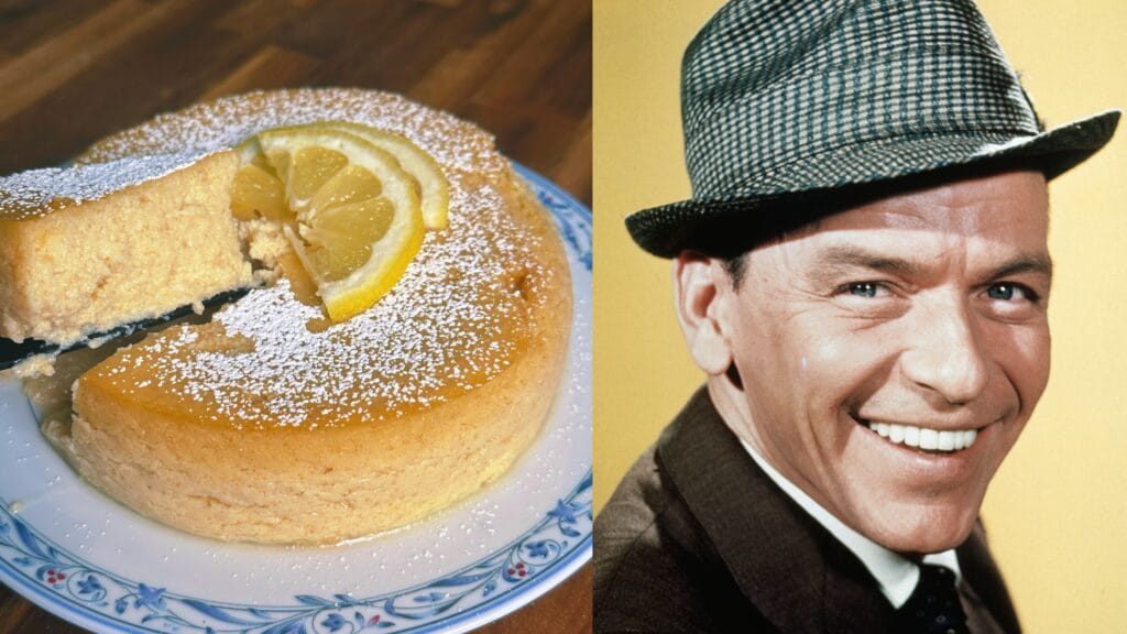 Round cake dusted with powdered sugar, garnished with lemon slice, one slice removed